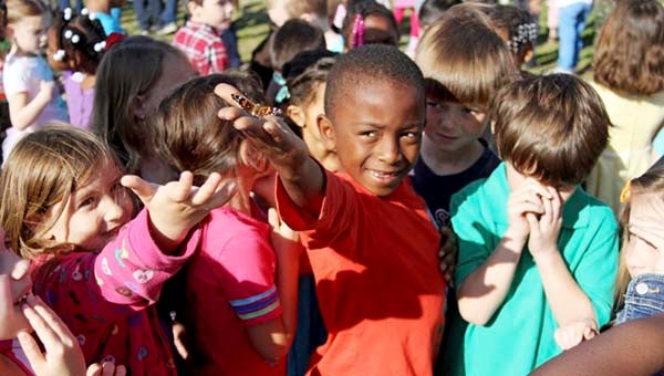 Jamariun Evans, a first-grader at Riverdale Elementary School, holds out his arm where a butterfly has landed. -- CAIN MADDEN | TIDEWATER NEWS