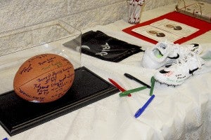 CAIN MADDEN | TIDEWATER NEWS Many former players signed a football and a pair of track shoes for their former coach, Larry Logan. He was an assistant football coach with Southampton High School from 1971 to 1980. -- Cain Madden | Tidewater News