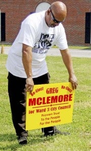 Greg McLemore places a sign in front of Engram Funeral Home. -- Cain Madden | Tidewater News