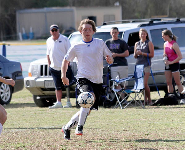 Southampton Academy’s Johnny Tribbett chases after a loose ball against Greenbrier Christian. He had 2 goals last Monday against BSH. -- CAIN MADDEN | TIDEWATER NEWS