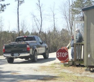 Guards at the trash site on Unity Road let a truck drive by without stopping it. -- CAIN MADDEN | TIDEWATER NEWS