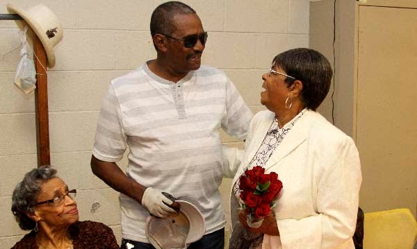 Mamie Wiggins of Franklin, right, gets a visit from her son, John Wiggins of Suffolk. He stopped in during the Mother’s Day celebration on Friday morning at the Dr. Martin Luther King Jr. Community Center. -- FRANK DAVIS | TIDEWATER NEWS