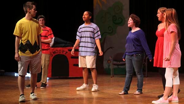 Charlie Brown (Warren Hastings), left, listens as Linus (Boyce Ward), Schroeder (Kirby Brooks), Lucy (Zoe Beale), the little red-headed girl (Alexa Boris) and Sally (Hannah Overstreet) sing to him. In back is Snoopy (Tyler Maynard). -- CAIN MADDEN | TIDEWATER NEWS