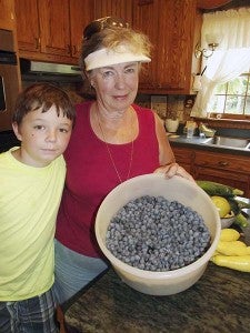 Gavenn Erwin and his grandmother, Janet Erwin of Zuni, show off a container of blueberries picked at her place. She and her husband, J.M., have been selling the berries they grow at their home for several years. -- STEPHEN H. COWLES | TIDEWATER NEWS