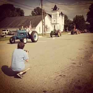 Cain in Newsoms taking pictures of the tractors going by.