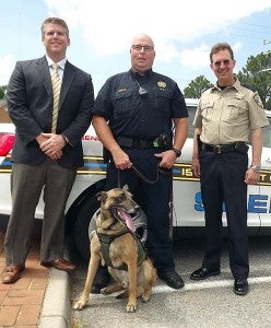Eko wears an XCaliber Harness that enables his handler, Patrol Deputy J.P. Hopko, center, to more easily maneuver the dog. With them are attorney Adam Carroll, left, with Isle of Wight County Sheriff Mark Marshall. Carroll and his law firm in Virginia Beach contributed the money to buy the special harness, valued at $600. -- STEPHEN H. COWLES | TIDEWATER NEWS