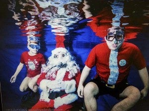 Kelsey Byrd, left, and Ethan Smith of Franklin suba dive with Santa Claus as a fundraiser for Area 29 Special Olympics. Smith had joined the organization in 2004. -- SUBMITTED
