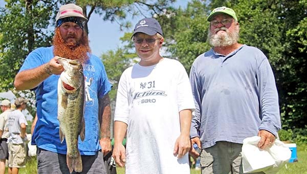 Matt Holt, left, caught the largest fish of the day at 6.5 pounds. He is standing with Spenser Holt, who went to high school with Matt, and Bob Holt, Matt’s father. -- CAIN MADDEN | TIDEWATER NEWS