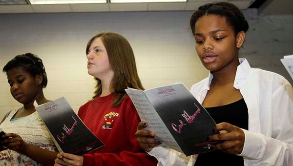 From left, Crystal Picot, 15, of Courtland, Chloe Tyndell, 12, of Courtland and Aleasha Bradshaw, 15, of Courtland practice singing as part of a Southampton High School choral workshop that featured Aaron Rice, a professor of music at Chowan University. -- CAIN MADDEN | TIDEWATER NEWS