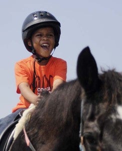 Rashawn Cumbo, 4, rides Shadow at Graz’n Acres.