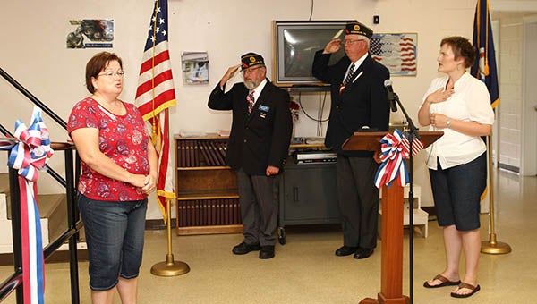 Kathy Brown sings the National Anthem during the posting of colors. Photo by Frank Davis.