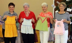 From left, Nancy Strachan, of Rwandan HUGS, and Audrey Gagner, Carol Sewell and Betty Edwards of Courtland Baptist Church. Not pictured is Nan Grissom, who also helped out with the project to provide dresses to Rwandan HUGS, which will go to needy children in the town of Mbyo.  -- CAIN MADDEN | TIDEWATER NEWS