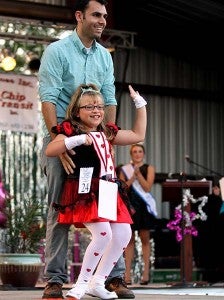 Rachel Blythe, 8, Junior Miss, along with a family friend, James Kannan -- Cain Madden | Tidewater News