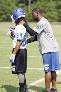 New Chowan University Hawks wide receivers coach Montario Hardesty works with Antjuan Randall at practice this past weekend. -- CAIN MADDEN | TIDEWATER NEWS