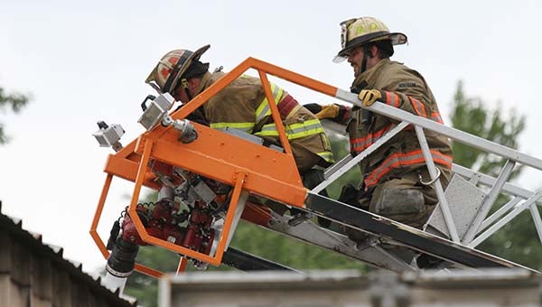 Firefighters from the Sedley and Hunterdale Volunteer Fire Departments work to overhaul the interior at Burgess Trucking Co. -- CAIN MADDEN | TIDEWATER NEWS