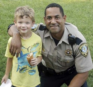 ​Deputy Alvin Wood with Blaine Edwards, the son of IOWSO Sgt. Anthony Edwards.