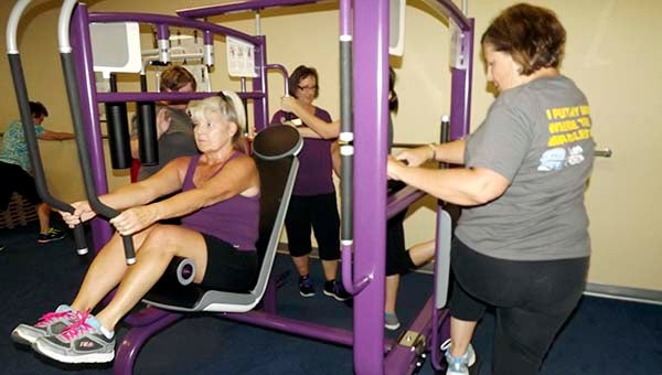 Jean West, left, works out on equipment designed for stretching at Curves on Armory Drive. In back is Jan Aleshire, owner of the Curves franchise in Franklin. They and other members will be welcoming visitors during  a Business After Hours on Wednesday, Sept. 17, from 5:30 to 7 p.m -- Stephen H. Cowles | Tidewater News