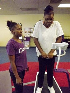 Cole, right,  works out on equipment for circuit training at Curves in Franklin. Cole, who’s been coming to the women’s exercise and health center for seven years, said her goal is to lose 20 pounds and “just to stay healthy.” With her is Jeneen Dimick, who is a coach at the center, as well as a Curves success story. -- Stephen H. Cowles | Tidewater News