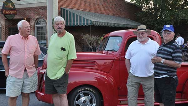 Local residents Dean Wagenbach, Donald O’Clair, Olin Romines and Paul Nixon take a moment to share a few memories and reminisce about old times as they admire all of the old cars and trucks on Main Street during the Franklin Cruise In.  -- Jim Hart | Tidewater News