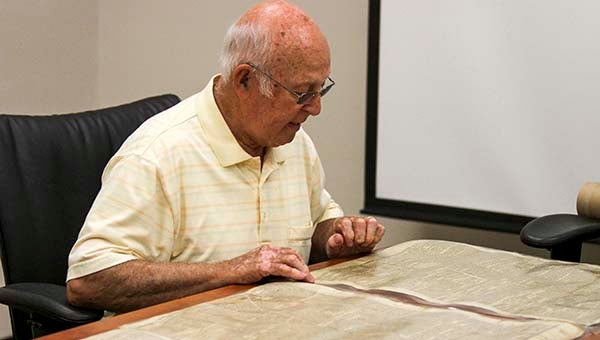 Bill Vick, who heads up the Ag and Forestry Museum, recently acquired some 1860s newspapers for public display. Vick looks over the newspapers for interesting headlines. -- Cain Madden | Tidewater News