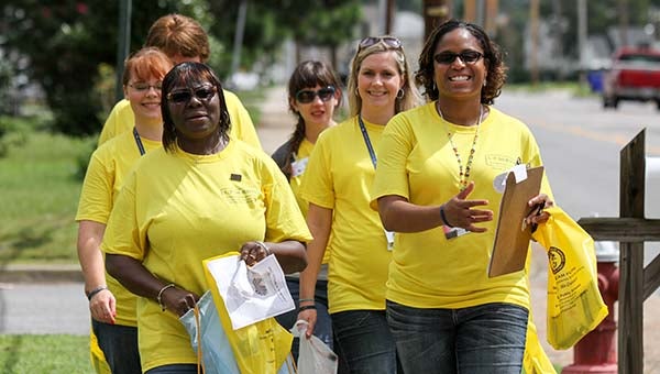 Teri Pittman, right, leads a group of teachers during the community bus tour.  -- CAIN MADDEN | THE TIDEWATER NEWS