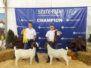 Taylor Cross, 14, left, and Lane Cross, 11, with their goats in the Winner’s Circle at the State Fair of Virginia.