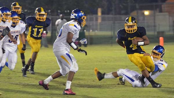 Javonte Baker avoids a few Cougar defenders on his way to a large gain. -- JIM HART | TIDEWATER NEWS