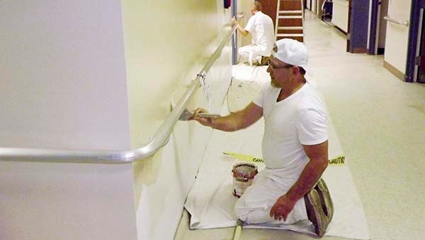 Kenny Fralick, foreground, and Wayne Ayers, both of Caspian Painting Inc., put on the first coat of paint in one of the hallways at East Pavilion. The long-term residential care center is undergoing major renovations. Ali Shafiee, the business owner, said he anticipates his company will be done in 60 days. They started on Monday doing prep work, such as cutting, scrapping, patching and priming. -- STEPHEN H. COWLES | THE TIDEWATER NEWS