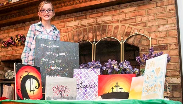 Madelyn Cosby, 11, stands with an array of artwork that she will be donating to benefit Graz’n Acres on Saturday, Oct. 11, from 11 a.m. to 3 p.m. at Sedley Baptist Church. -- CAIN MADDEN | TIDEWATER NEWS