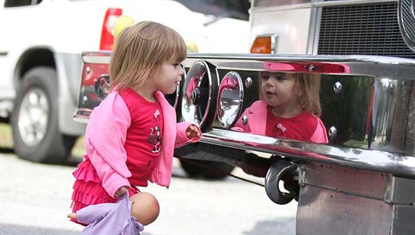 Mackynzie Doyle, 2, of Sedley checks out one of the sirens on the front of the fire truck. -- CAIN MADDEN | THE TIDEWATER NEWS