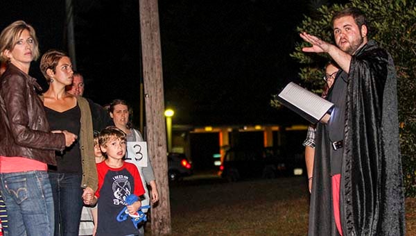 Diane Felts, Jessica Xinos and Dylan Xinos, 6, listen as Garrett Piersa talks about the Rebecca Vaughan house. He helped lead ghost tours of Courtland. -- Cain Madden | The Tidewater News