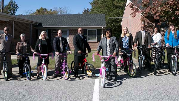 Southampton County Schools Superintendent Dr. Alvera Parrish, center, with other members of the school office show off the bicycles they’re donating for a program to motivate children to read. -- SUBMITTED