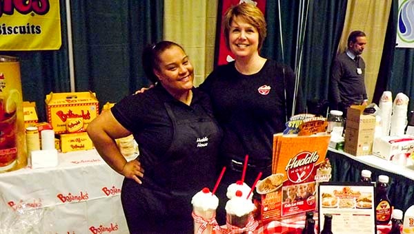 Ashley Whitehead, right, operations manager of Huddle House stands with one of her employees at the Franklin-Southampton Community Expo. -- Andrew Lind | Tidewater News