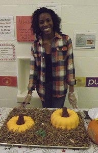Katrina Williams, a volunteer at Southampton Head Start, serves pumpkin spice cake at the program’s annual Thanksgiving feast. -- ANDREW LIND | The Tidewater news