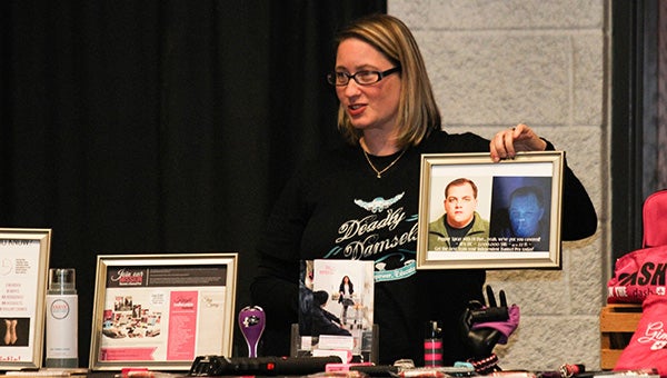 Courtney Wallace shows off some of her Damsel in Defense products, including pepper spray that leaves a dye on people that shows up under a black light.