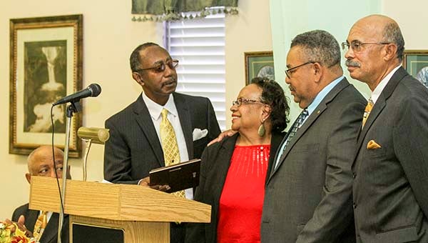 Herman Charity, left, and Littleton Parker, right, present an award to Ida and Charlie Williams of Williams’ Florist in Courtland. -- Cain Madden | the Tidewater News