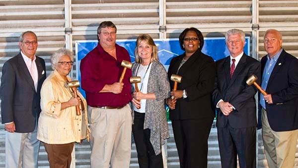 Since they couldn’t break ground on the project, the Franklin City Council members and leaders of Highground Services Inc. decided to take a ceremonial hammer to the place. From left, Frank Rabil, Mary Hilliard, Jim Strozier, Lisa Strozier, Mayor Raystine Johnson-Ashburn, City Manager Randy Martin and Benny Burgess. -- Cain Madden | Tidewater News