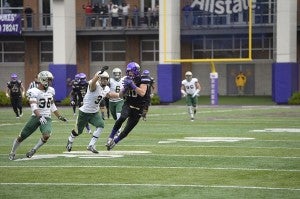 After making a catch, James Madison University and Windsor native Daniel Brown moves to avoid a tackle in a game against the College of William & Mary Tribe. Courtesy JMU Athletics.