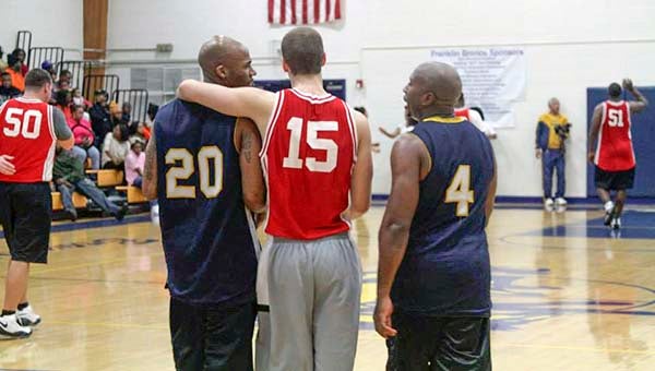 Lakenneth Kindred, left, Nick Doyle and James Holeman  share a moment of friendship between the schools. -- SUBMITTED