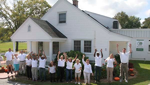 Employees at Hubs jump for joy in celebration of the company's 60th anniversary. Earlier this year, they gave of their time and talents to help individuals and organizations in Franklin and Southampton County. -- Courtesy