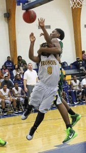 No foul is called as Quinton Lowe tries to get a layup shot in at the lane. -- Frank Davis | Tidewater News