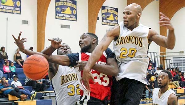 Travis Tinsley draws heat on shot from Daquan Frazier, left and Lakenneth Kindred. -- FRANK DAVIS | TIDEWATER NEWS