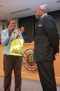 On behalf of the Franklin City Public School Board, Chair Edna King presents Division Superintendent Willie J. Bell with a gift bag for achieving his doctorate from Cambridge College in Boston. Bell defended his dissertation on Dec. 17. -- Cain Madden | Tidewater News