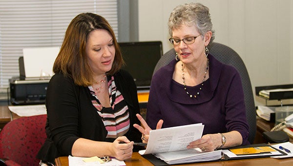 Anne Bryant, right, goes over some aspects of the United Way executive director job with Trish Edwards. Edwards is Bryant’s successor, and will have her first day on her own Monday.