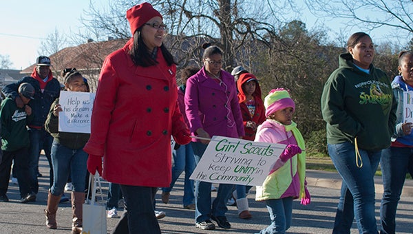 Girl Scout Troop No. 5073 leader Kisha Watford, left, Indiya Reid and others walk on Oak Street in Franklin during the third annual Keeping Unity in the Community Martin Luther King March in January 2013. This Monday, Jan. 19, the event will begin at 9 a.m. at the Paul D. Camp Community College Campus.