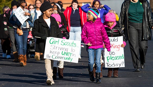 Indiya Reid and Mia Warren, Girl Scouts with Group No. 5073, lead the annual community walk.