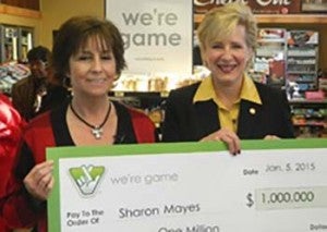 Sharon Mayes, left receives her check from Virginia Lottery Executive Director Paula Otto.
