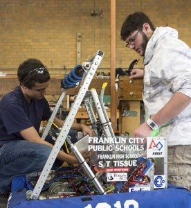 Franklin Student Donald Wintersteen, left, explains functions of last year’s robot to a member of a visiting team. -- Murray Thompson | Tidewater News