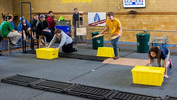 From left, Elijah Steele, Chad Biever and Franklin’s Cindy Mitrovic act out what their robots would do in the autonomous portion of the game. -- MURRAY THOMPSON | TIDEWATER NEWS