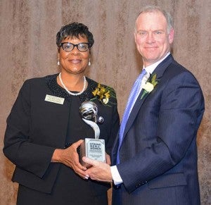 Sheila Baxter of Franklin accepts an award from Dan Weekley, vice president of Corporate Affairs at Dominion. -- SUBMITTED
